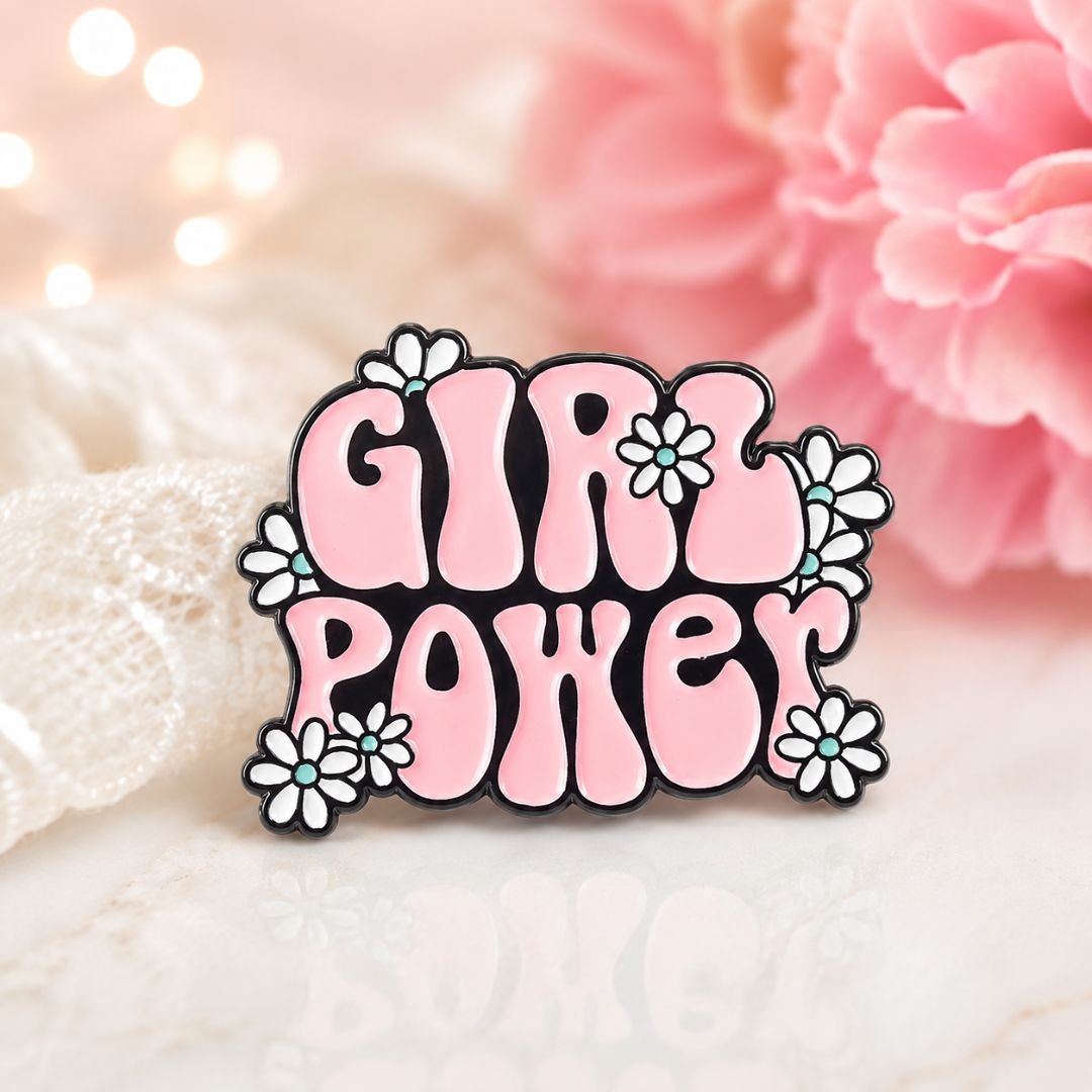 Pink Girl Power enamel pin with floral details.