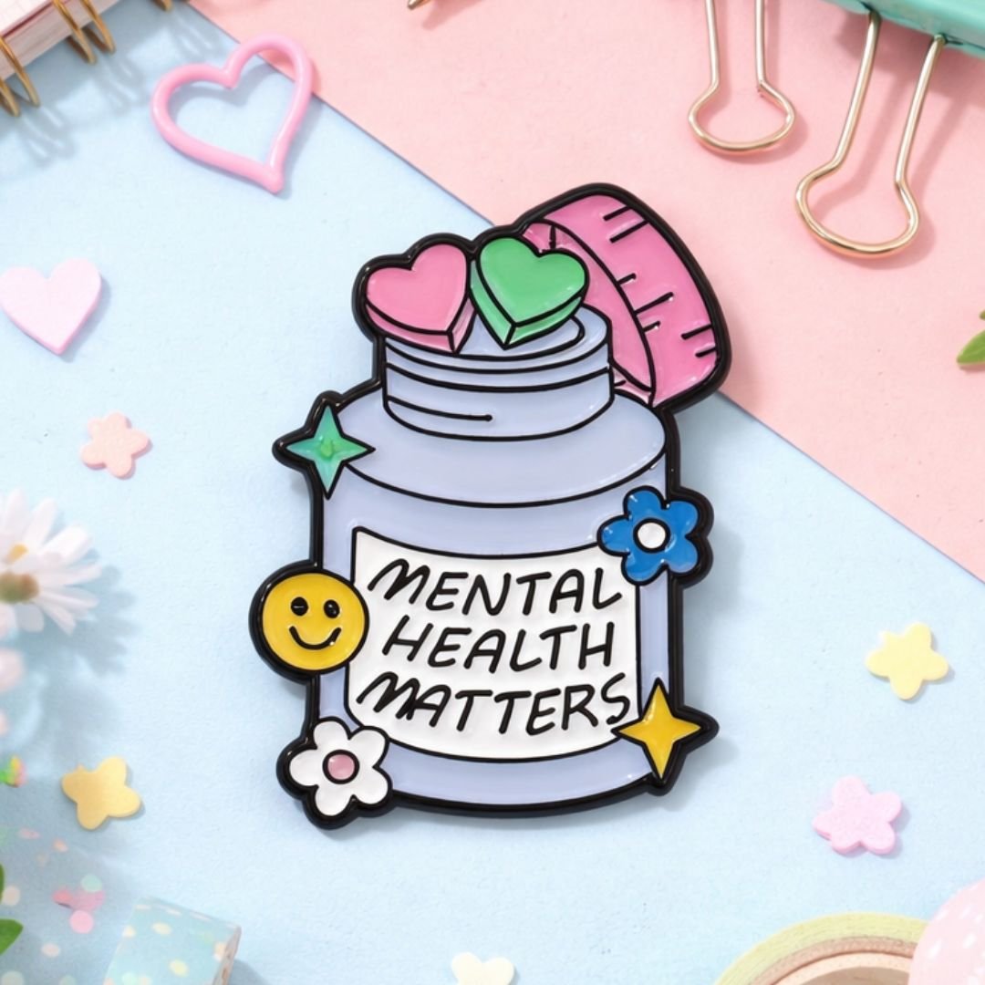 Mental Health Matters enamel pin with pastel layers, hearts, star, flower and smiley face.