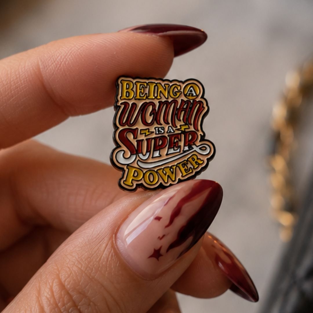 Being a Woman Is a Superpower decorative enamel pin with multicolour lettering