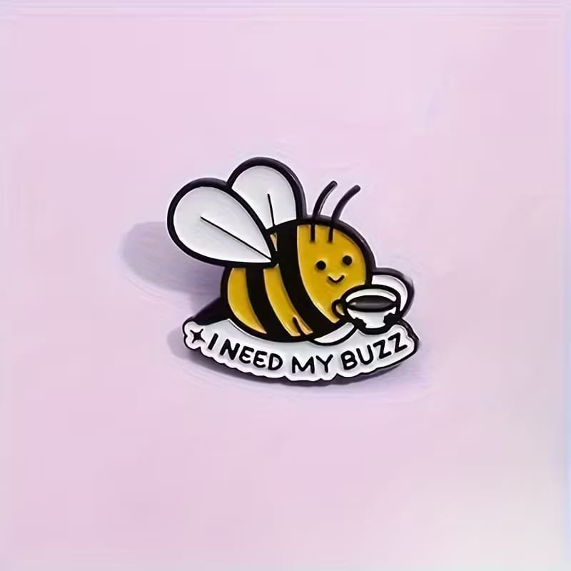 Bee enamel pin with yellow and black stripes, white wings and dimensions of 30 × 27 mm
