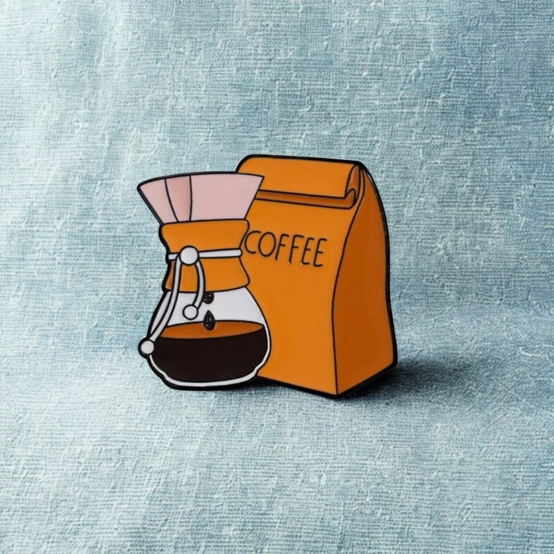 Pour-over coffee Chemex and orange coffee bag enamel pin illustration with 3 cm dimensions.
