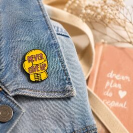 Never Give Up Motivational Enamel Pin – Yellow boxing Design