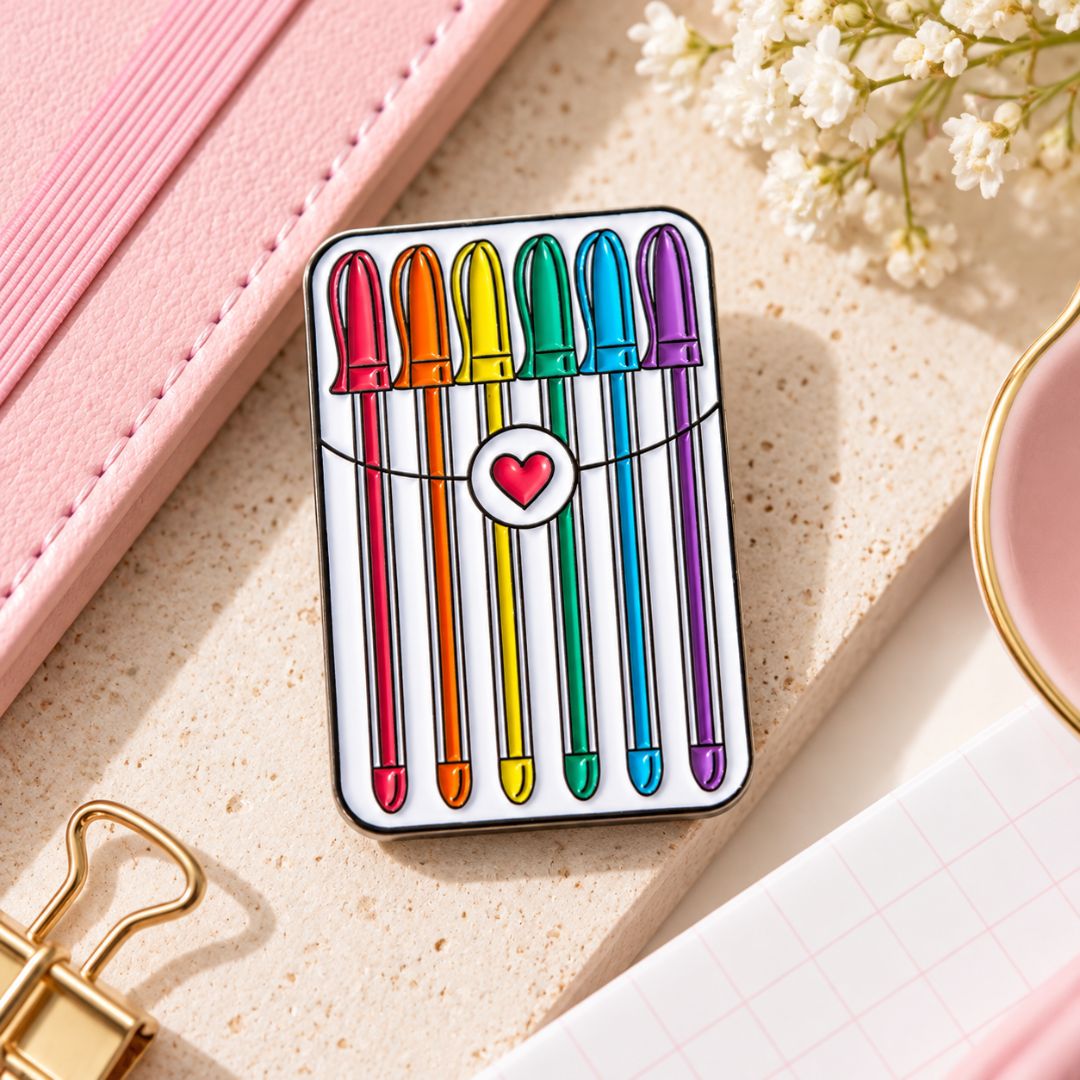 Gel Pens Lapel Pin featuring six rainbow-coloured pens and heart detail