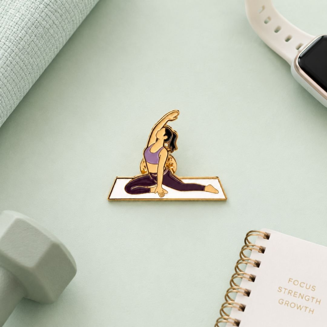 Yoga pose enamel pin featuring an illustrated figure stretching on a yoga mat